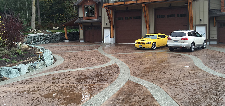 Artistic Concrete pouring Integral colored Roman slate stamped concrete driveway with exposed aggregate borders in the Camano Island area. 